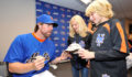 New York Mets baseball player R.A. Dickey autographs a cap for Neva  and Vaughn Coleman during a pregame ceremony. The Coleman children’s father and an uncle died in the attacks. (Photo 5 of 10 photo(s)).
