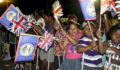 Children waving flags to greet Prince Harry (Photo 1 of 5 photo(s)).